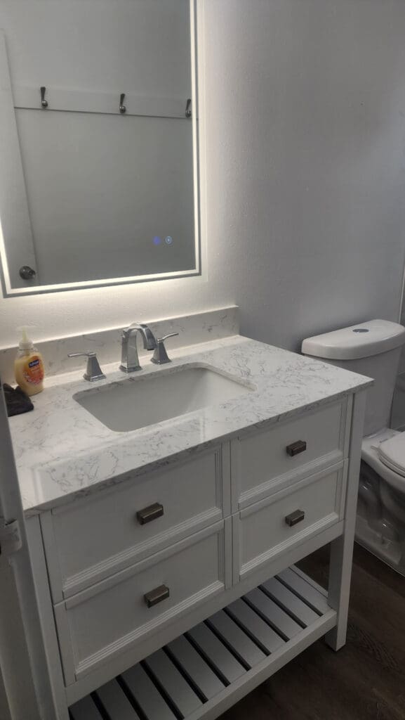 A bathroom with a sink and mirror in it